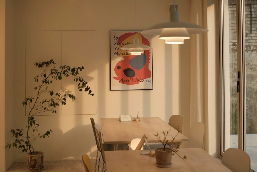 Lichte eethoek met een witte hanglamp en een plant